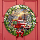 Decorative wreath with a vintage red truck and farm barn and windmill and Christmas scene on a red door.