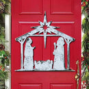 Red door with solid white rustic distressed Christmas nativity scene decoration, surrounded by festive greenery.