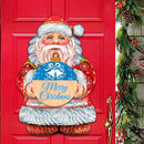 Red door with Santa Claus decoration and 'Merry Christmas' sign, surrounded by holiday decorations.