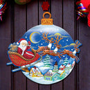 Decorative door hanger with Santa Claus and reindeer sleigh on Christmas eve delivering gifts, surrounded by festive red and green decorations.