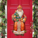 Red door with a decorative figure of Saint Nicholas holding a Christmas tree, surrounded by festive greenery.