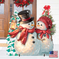 Vintage Snowman & Snowlady Lawn & Porch Outdoor Holiday Decoration. One snowman wears a black top hat with a red band and a bright red scarf, while the other wears a red knit hat and matching red scarf with a lantern and Christmas tree.