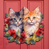 Decorative Christmas front door sign with two cats and floral designs, surrounded by Christmas garlands and decorations.
