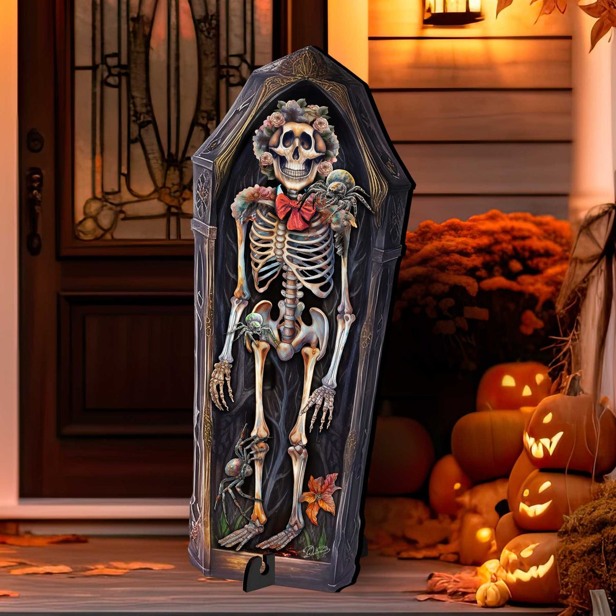 Skeleton Coffin Freestanding Decor Outdoor Wood Yard Sign: A coffin-shaped Halloween decoration featuring a detailed skeleton with a red bow tie and floral hair, displayed on a porch surrounded by pumpkins and warm autumn decor.