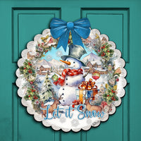 Decorative Christmas wreath with snowman and 'Let it Snow' text on a teal door, surrounded by garland and lights.