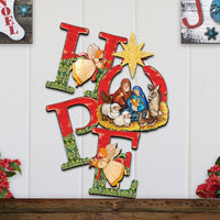 Decorative wall art with Christmas nativity scene and 'hope' letters on a white wooden panel background.