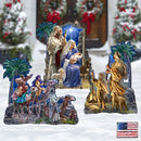 A multi-piece Christmas nativity scene set displayed in a snowy outdoor-style setting. The set includes a central nativity scene with Mary, Joseph, baby Jesus, an angel, and a shepherd, plus three separate figures depicting the Three Wise Men on camels traveling to Bethlehem.