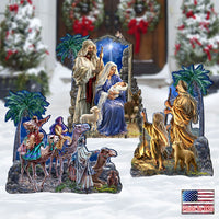 A multi-piece Christmas nativity scene set displayed in a snowy outdoor-style setting. The set includes a central nativity scene with Mary, Joseph, baby Jesus, an angel, and a shepherd, plus three separate figures depicting the Three Wise Men on camels traveling to Bethlehem.