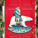 Decorative door hanger with Santa Claus and polar bear on a red door, surrounded by Christmas decorations.