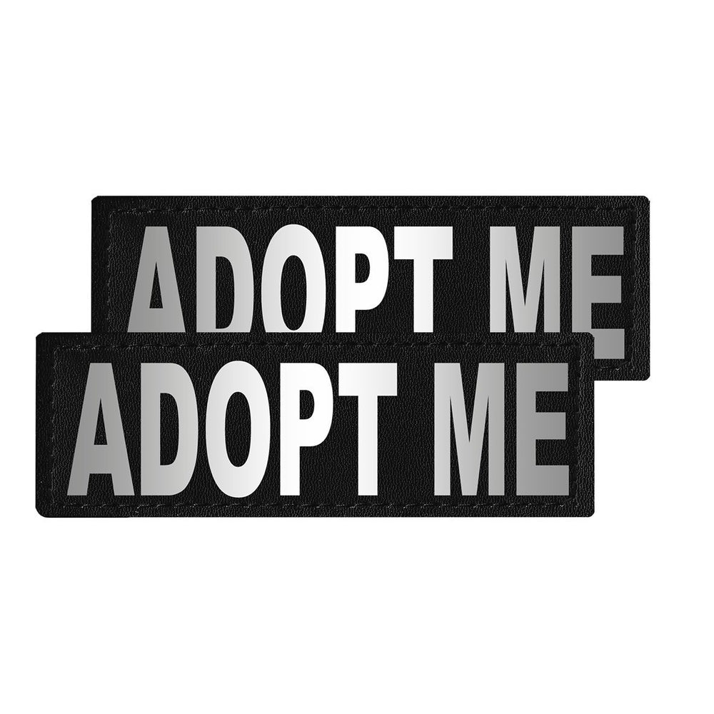 Two black patches with 'ADOPT ME' text on a white background