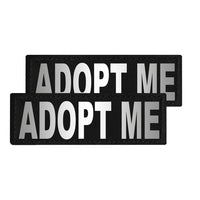 Two black patches with 'ADOPT ME' text on a white background