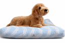 rectangle Designer Pet Bed with a  Beachy Coastal Light Blue and White Design with a brown dog lying on it. 