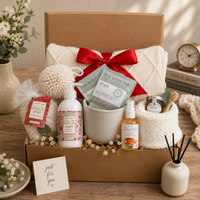 Thinking of you gift basket with Herbal Tea (2 pkgs.), Tiptree of England Honey (1oz.), 49”x61” Throw Blanket, Cream Ribbed Socks, Floral Lotion, Stoneware Speckle Mug, Floral Bath Salts, Linen Refresher Spray, Wood Honey Dipper, Exfoliating Bath Round.