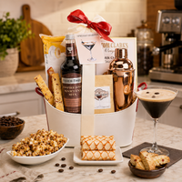 liquor Espresso martini cocktail Gift basket with drink mix, a copper cocktail shaker, popcorn, snacks on a kitchen counter.