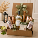 liquor Gift basket with Moscow Mule cocktail ingredients including drink mix, copper mugs, and club soda, tied with a green ribbon.