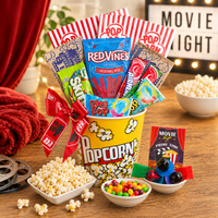 Movie night gift basket with popcorn, candy, and snacks on a wooden table.