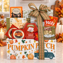 An Autumn Treats Gift Basket for Thanksgiving and Fall with Food and Snacks including Pocky Amaretti sticks, Brie double cream cheese, Jack Daniel's, and pumpkin spice cookies, arranged in a white box with autumn illustrations.