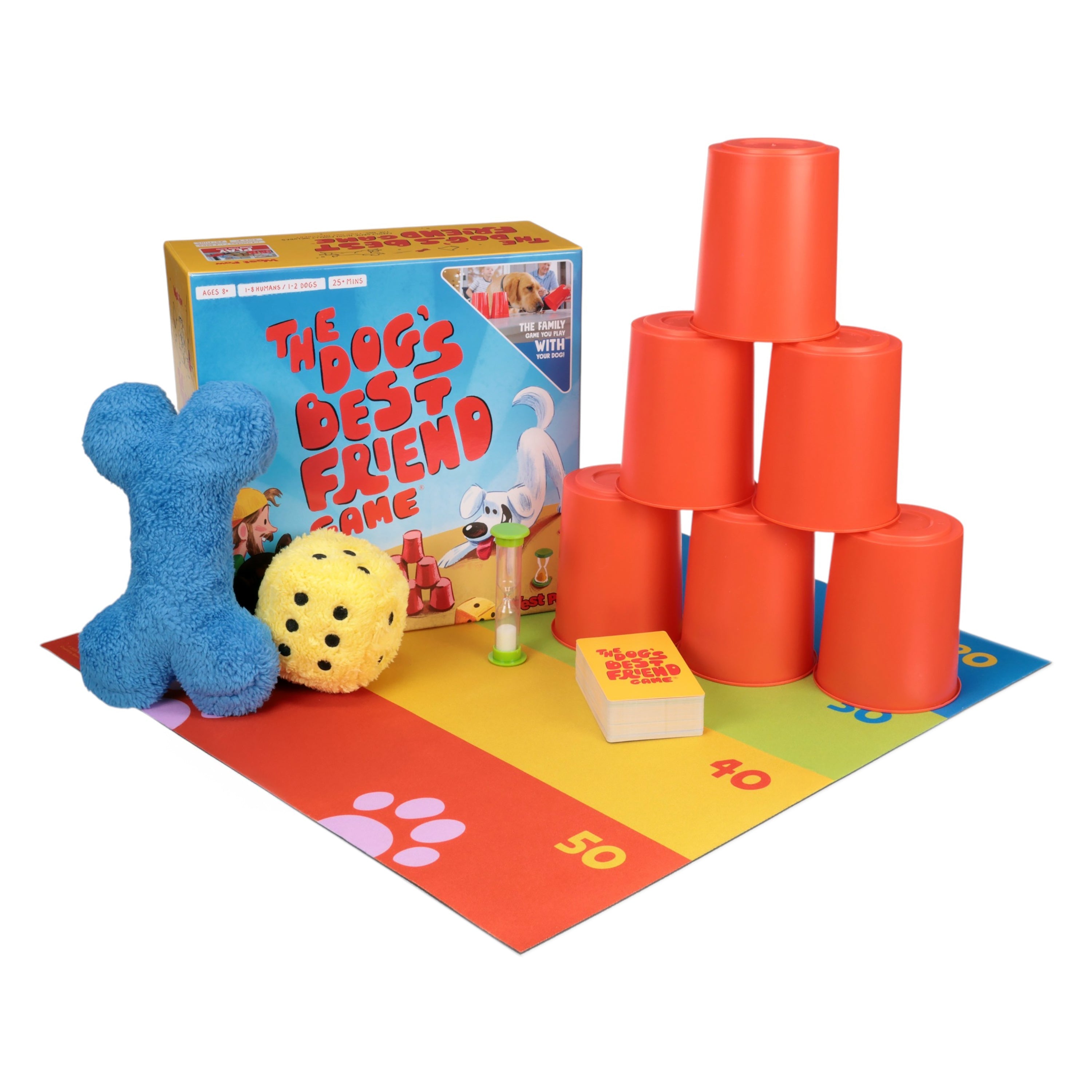 Colorful dog toys and game components on a mat with dog enrichment toy 'The Dog's Best Friend Game' box to increase the bond between dogs and their people.
