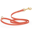 Coral/terracotta waterproof biothane cat or dog leash with gold colored brass snap clip that comes in widths of 1/2", 5/8" and 3/4" and is 6 feet long.