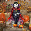 A Halloween yard sign featuring a Dracula vampire holding a small cat, surrounded by tombstones, jack-o'-lanterns, hay bales, pumpkins, and autumn leaves against a rustic wooden fence backdrop.