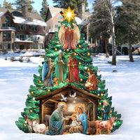 Outdoor Decorative Christmas tree with a nativity scene, wise men and angel with a star on top in a snowy outdoor setting