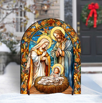 Decorative nativity scene with stained glass style art in front of a snowy outdoor background.