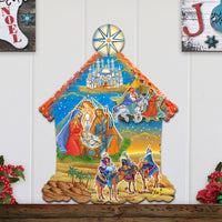 Decorative nativity scene wall hanging with three wise men and baby Jesus on a white wooden panel background.