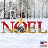 Large decorative wooden sign spelling NOEL in red and gold glitter, with a nativity scene cutout in the center and a gold star of bethlehem above, set against a snowy outdoor background with a small white house and trees. A small 'Made in USA' flag badge appears in the bottom right corner.