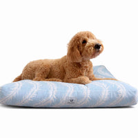 light blue and white cat or dog bed with feather print.