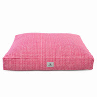 A square pink dog bed with a textured pink and white woven pattern on a plain white background.