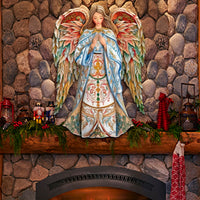 Elegant Angel of Hope Wood Art-Indoor/Outdoor Holiday Christian Decor on a stone fireplace mantel with festive decorations.