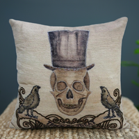 Decorative pillow with skull and top hat design on a textured surface.