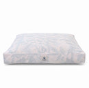 A designer dog bed with an ivory and gray botanical pattern, on a plain white background.