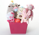 A pink dog toy gift basket filled with plush toys, including a white Hello Kitty figure, a pink bunny, a pink teddy bear, a gray plush, and a cream bear, with a small red 'Happy Birthday' ball, on a white background.