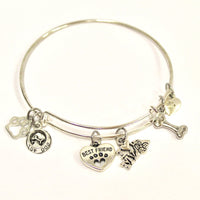 Stainless steel bracelet with dog-themed charms on a white background