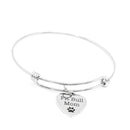 Silver bracelet with a heart-shaped tag that reads 'Pit Bull Mom' on a white background