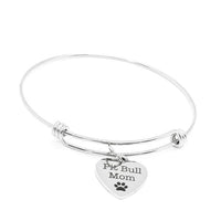 Silver bracelet with a heart-shaped tag that reads 'Pit Bull Mom' on a white background