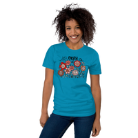 aqua blue unisex t-shirt with encouraging saying "it's okay to be different" in red, pink floral design