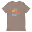 brown t-shirt with colorful text 'Foster Adopt Volunteer Donate' to support animal shelter pets