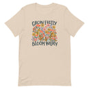 beige Unisex T-shirt with be yourself message "Grow Freely Bloom Wildly" in a field of wildflowers