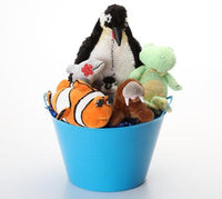 A collection of plush stuffed animals arranged inside a bright blue bucket on a clean white background. The toys include a penguin, a green turtle, an orange and white clownfish, a brown animal, and a small black-and-white chick.